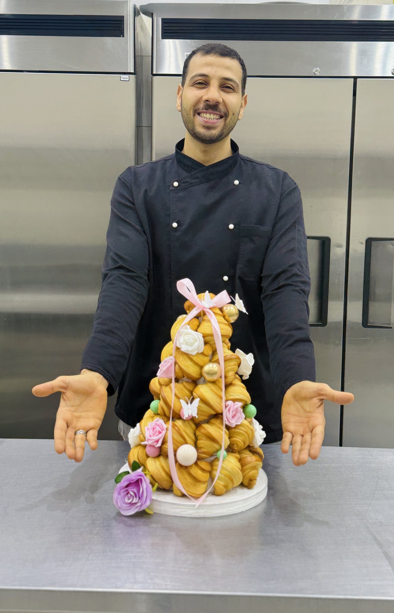 Chef Mohamed presenting a croquembouche